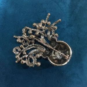 Detailed back view of vintage octopus brooch with secure safety pin and metallic texture