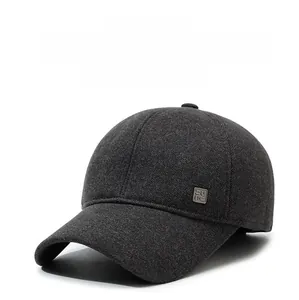 Close-up of thick dark grey wool winter baseball cap with ear flaps and side patch