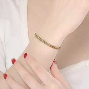Detailed view of an adjustable gold snake bone chain bracelet worn on a model wrist