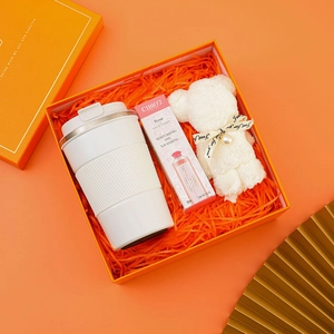 Premium orange gift set with insulated tumbler, rose hand cream, and creative bear towel