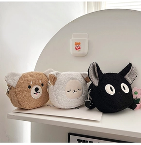 Detail showing plush cartoon animal crossbody bags in brown bear, white sheep and black cat
