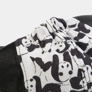Detail of PU leather stitching with panda canvas pattern and stitching on beret cap