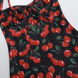 Close-up of black bodycon dress with red cherry print and front drawstring neckline detail