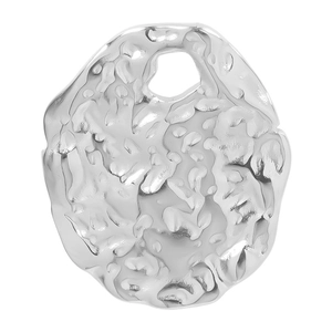 Macro view of hammered texture on irregular silver stainless steel oval pendant