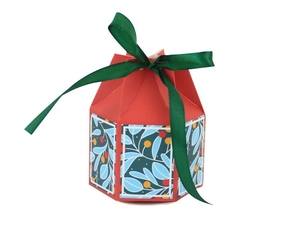 Detail of red hexagonal Christmas candy gift box with green ribbon and berry pattern