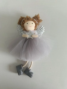 Macro detail of Christmas angel ornament with purple mesh skirt and silver wings