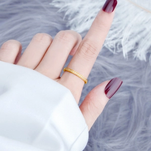 Detailed view of gold plated titanium steel ring with micro paved pavé zirconia stones