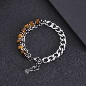 Detail of stainless steel curb chain and natural tiger eye stone beads on the bracelet