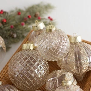 Champagne gold Christmas tree ornaments set with assorted textured patterns in a basket