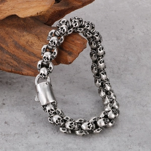 Gothic skull bracelet in vintage silver stainless steel on decorative wood base