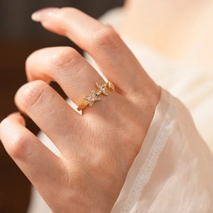 Close-up of vintage gold ring featuring three pink star-shaped zircon crystals