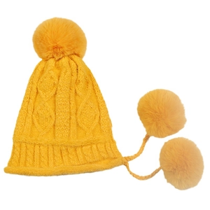 Bright yellow cable knit trapper hat with fluffy pom-poms for winter warmth