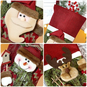 Detailed view of burlap Christmas stockings featuring plush Santa, snowman, and elk designs