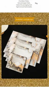 Modern marble pattern gift bags in four sizes with silver handles and gold foil accents