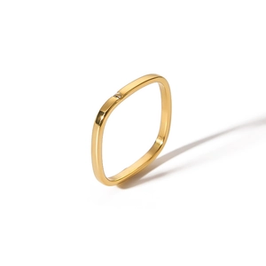 Macro shot of minimalist gold square ring featuring a single sparkling diamond stone
