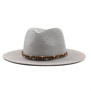 Detail of grey straw fedora hat featuring boho beaded band and fine woven texture