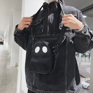 Detailed view of the quirky ghost-shaped PU crossbody bag worn by a model in black
