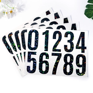 Detail view of reflective 4-inch black vinyl mailbox numbers with holographic sequins