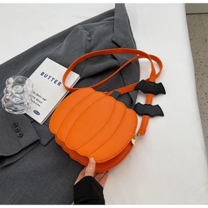 Detail of pumpkin crossbody bag with black bat accents on orange shoulder strap