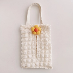 Detail of white popcorn textured car tissue holder with a yellow sunflower decoration