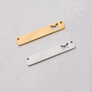 Close-up of rectangle butterfly charms in gold and silver for jewelry making