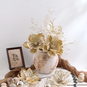 Elegant champagne gold artificial magnolia flowers in a vintage vase for Christmas decor