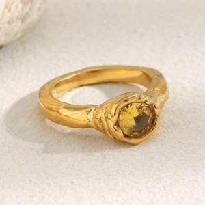Macro detail of 18K gold plated ring featuring organic lava texture and yellow zircon gem