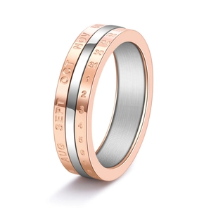 Macro detail of rose gold and silver spinning calendar ring with engraved dates