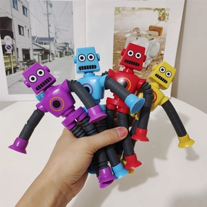 Macro view of four colorful suction cup robot toys with flexible telescopic limbs
