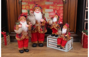 Detailed close-up of standing Santa Claus figurines with classic red and plaid fabric textures