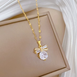 Macro shot of gold butterfly necklace pendant with micro-pave crystals and large round gem
