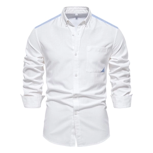 Detail of white cotton Oxford shirt showing blue contrast stitching and chest pocket