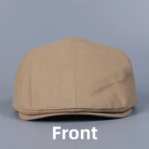 Front view of khaki cotton flat cap featuring classic twill fabric and vintage stitching