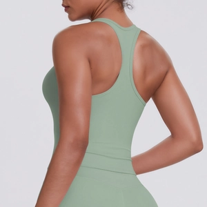 Detail view of the racerback design and sage green matte fabric on sports yoga top