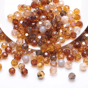 Macro shot of faceted crystal football beads in amber and brown tones for DIY jewelry