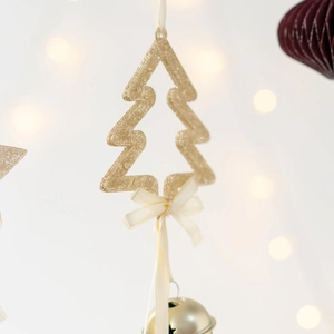 Golden Christmas tree pendant with bell and ribbon on a soft bokeh background