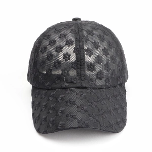 Detailed view of black lace baseball cap with intricate 3D floral embroidery mesh
