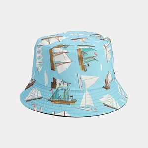Detailed view of the nautical sailing print and cotton canvas texture on a light blue bucket hat