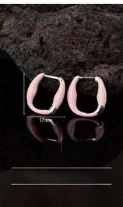 Detail view of pink enamel hoop earrings with silver-plated copper texture and measurements