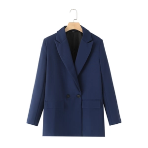 Detail of double-breasted navy blue blazer featuring notch lapels and flap pockets