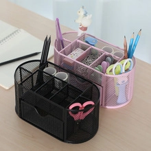 Detail view of multi-compartment mesh desk organizer with drawers in black and pink metal