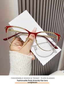 Detail of red and gold cat-eye glasses frame with intricate metal anti-slip textures