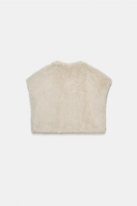 Detailed macro view of beige faux fur texture on short sleeveless mink-style winter vest