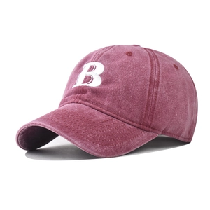 Detailed close-up of premium washed cotton texture and white letter B embroidery on baseball cap