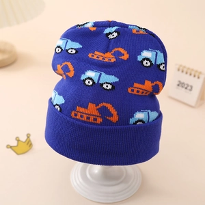 Detailed knit of navy winter baby hat featuring blue cars and orange excavators patterns