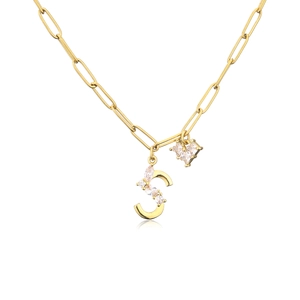 Close-up of golden paperclip chain with zircon heart and pavé letter S pendant