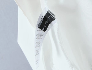 Detail view of clothing care label showing 89% Nylon and 11% Elastane fabric composition