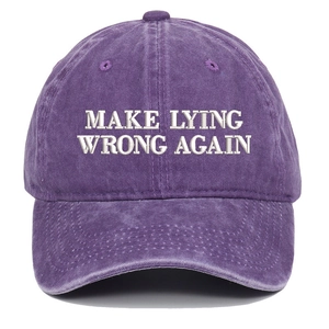 Close-up of white Make Lying Wrong Again embroidery on a washed purple cotton baseball cap