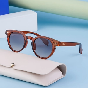 Fashionable tortoise shell oval sunglasses with gradient lenses and cream flip case