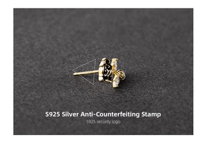 Macro shot of S925 silver vintage black rose stud earring with white marquise zircons